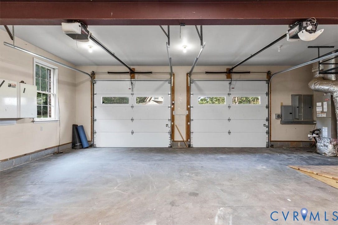 1437 Palmore Road, Powhatan, VA 23139 Two-car garage featuring automatic openers and insulated doors with upper-level window inserts