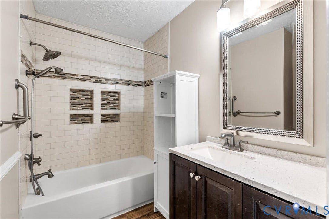 1437 Palmore Road, Powhatan, VA 23139 Bathroom featuring a tub/shower combination with subway tile surround and decorative mosaic accents