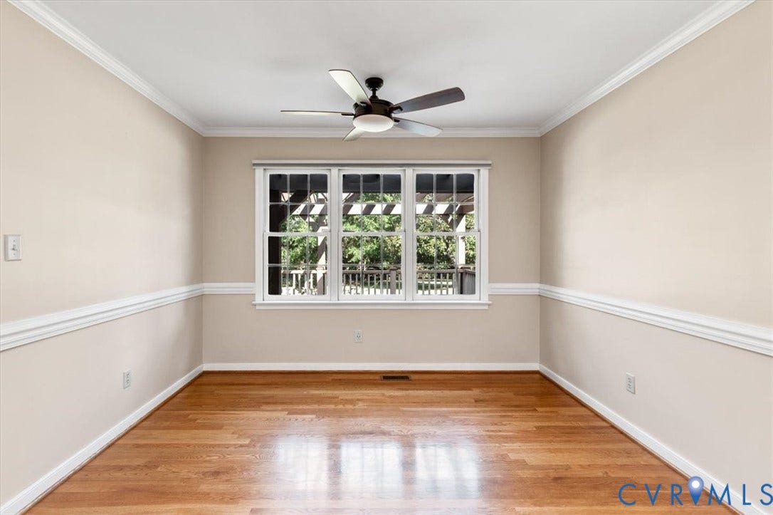 1437 Palmore Road, Powhatan, VA 23139 Room featuring wood-finish flooring, a three-panel window with white trim, and a ceiling fan with integrated lighting