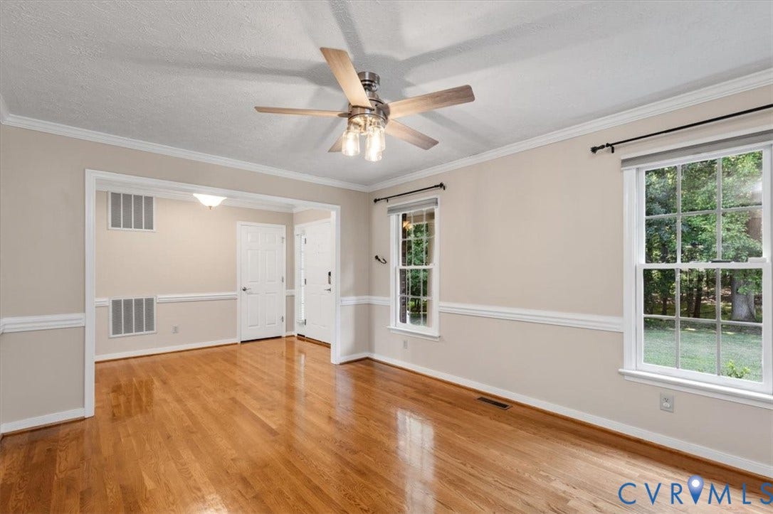 1437 Palmore Road, Powhatan, VA 23139 Spacious room featuring wood-finish flooring, white crown molding, and a modern ceiling fan with light fixture