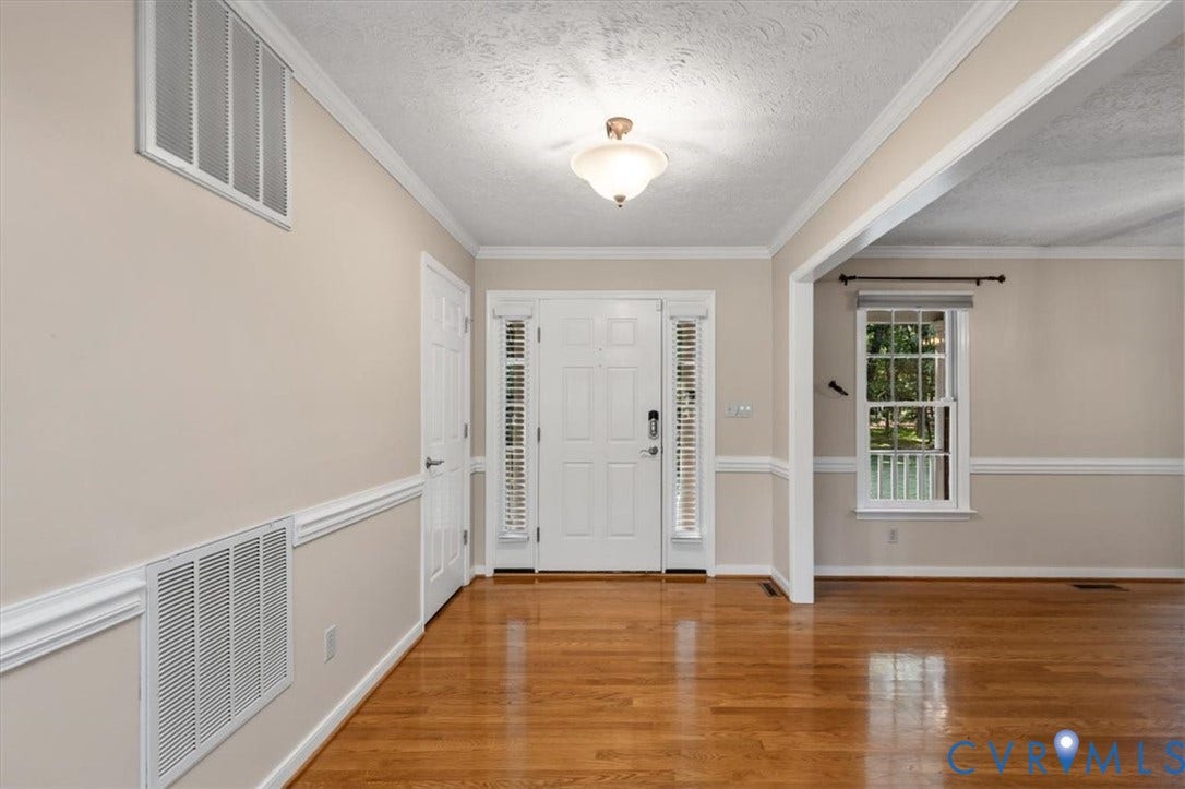1437 Palmore Road, Powhatan, VA 23139 Entry foyer featuring wood-finish flooring, a white paneled entry door with sidelights, a transom window, and crown molding