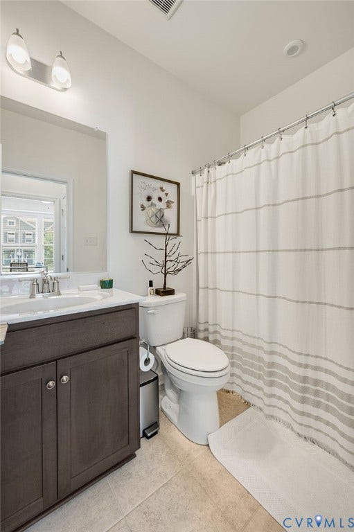 9217 Cerulean Place, Goochland, VA 23238 Bathroom featuring a dark wood-finish vanity with an integrated sink, polished chrome faucet, and overhead vanity lighting