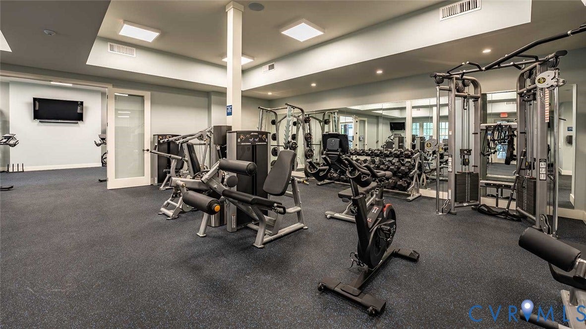 9217 Cerulean Place, Goochland, VA 23238 Spacious fitness center featuring rubberized flooring, comprehensive weight training equipment, cardio machines, and large wall-mounted mirrors