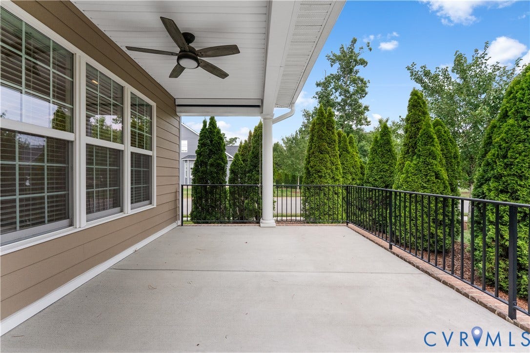 7238 Shenfield Avenue, Minutes To Short Pump, Glen Allen, VA 23059 Expansive covered patio featuring a ceiling fan, durable concrete flooring, and a black wrought iron railing