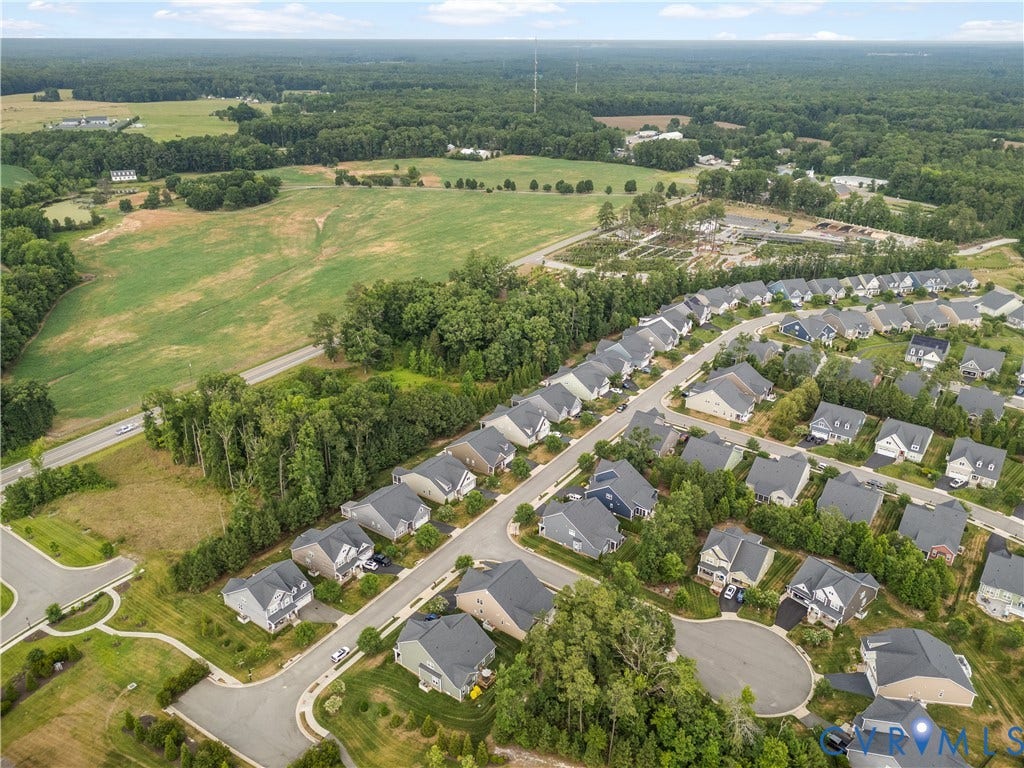 7238 Shenfield Avenue, Minutes To Short Pump, Glen Allen, VA 23059 Aerial perspective showcasing a residential community with uniform housing designs, surrounded by expansive green spaces and mature trees