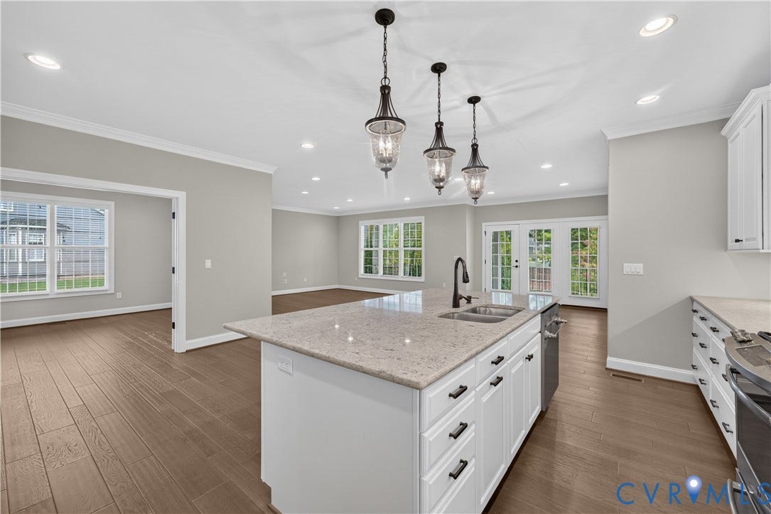 7238 Shenfield Avenue, Minutes To Short Pump, Glen Allen, VA 23059 Spacious kitchen island featuring a dual-basin sink and three pendant lights
