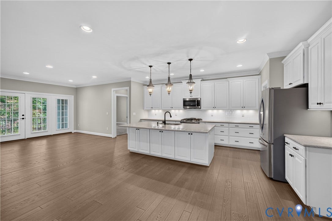 7238 Shenfield Avenue, Minutes To Short Pump, Glen Allen, VA 23059 Spacious interior featuring wood-finish flooring and a kitchen island with pendant lighting