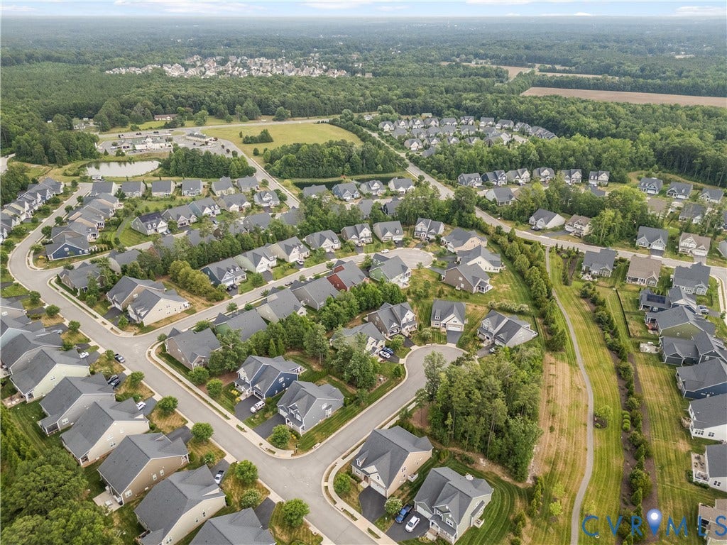 7238 Shenfield Avenue, Minutes To Short Pump, Glen Allen, VA 23059 Aerial view showcasing a residential community with numerous homes featuring dark shingle roofs, surrounded by extensive green spaces and mature trees