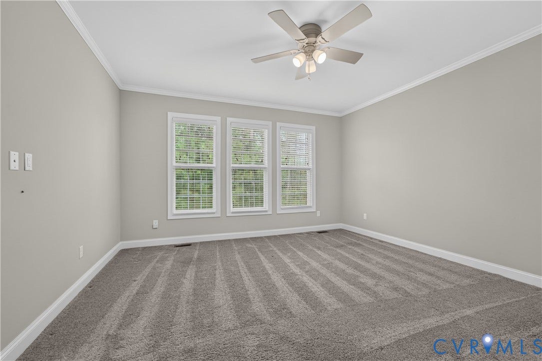7238 Shenfield Avenue, Minutes To Short Pump, Glen Allen, VA 23059 Spacious room featuring neutral wall tones, triple windows with blinds, a ceiling fan with integrated lighting, crown molding, and plush carpeting