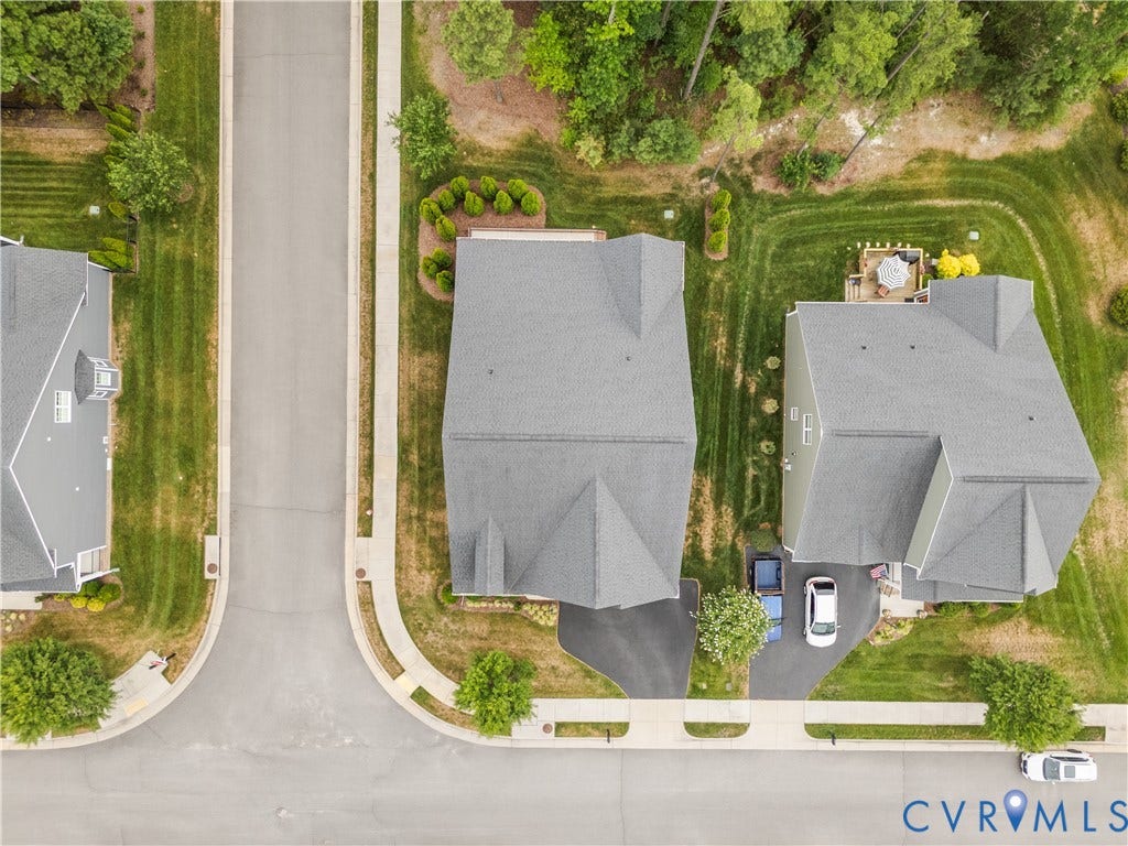 7238 Shenfield Avenue, Minutes To Short Pump, Glen Allen, VA 23059 Aerial perspective showcasing a residential property with a multi-level roofline and a paved driveway