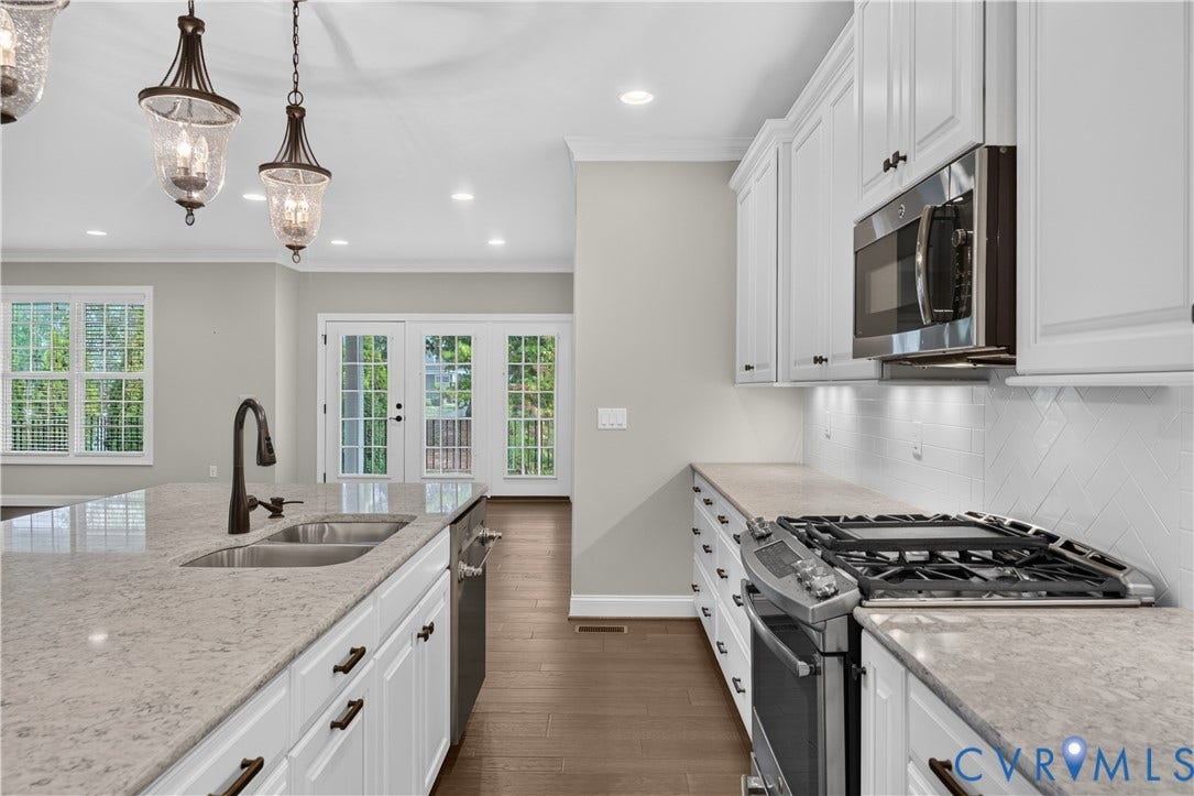 7238 Shenfield Avenue, Minutes To Short Pump, Glen Allen, VA 23059 Kitchen featuring white cabinetry, light-toned countertops, a stainless steel gas range, and a matching microwave