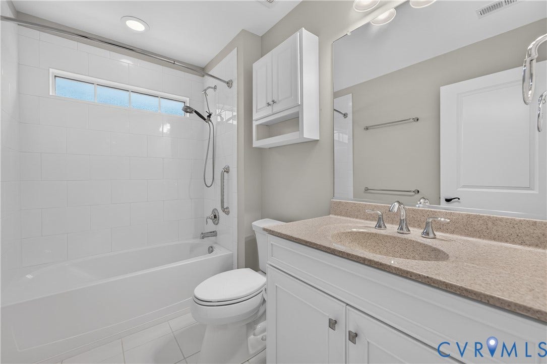 7238 Shenfield Avenue, Minutes To Short Pump, Glen Allen, VA 23059 Bathroom featuring a spacious vanity with an integrated sink and light-toned countertop, a full mirror, and a white cabinet
