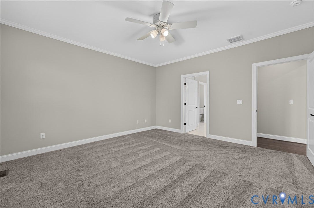 7238 Shenfield Avenue, Minutes To Short Pump, Glen Allen, VA 23059 Spacious room featuring neutral wall tones, gray patterned carpeting, crown molding, and a ceiling fan