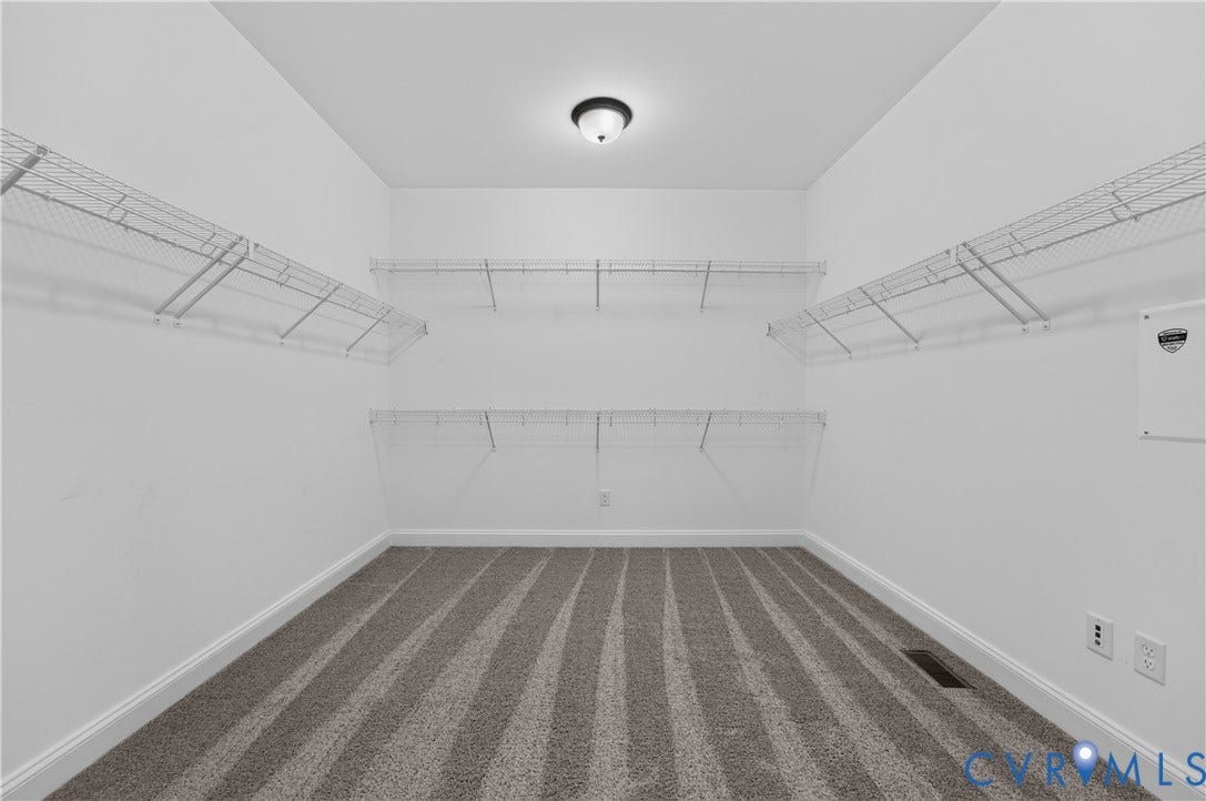 7238 Shenfield Avenue, Minutes To Short Pump, Glen Allen, VA 23059 Spacious walk-in closet featuring white wire shelving, neutral-toned carpet flooring, and a flush-mount ceiling light fixture