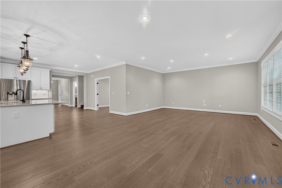 7238 Shenfield Avenue, Minutes To Short Pump, Glen Allen, VA 23059 Expansive living area featuring wood-finish flooring, recessed lighting, and a window with blinds