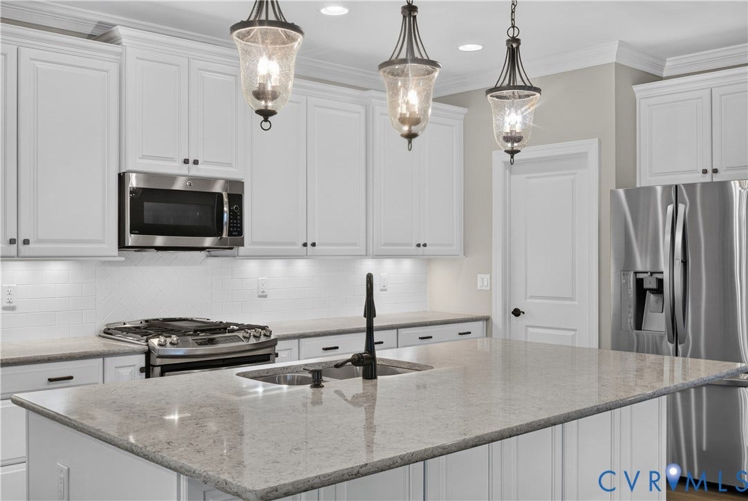 7238 Shenfield Avenue, Minutes To Short Pump, Glen Allen, VA 23059 Kitchen featuring a large island with a sink, stainless steel appliances, white shaker cabinetry, pendant lighting, and subway tile backsplash