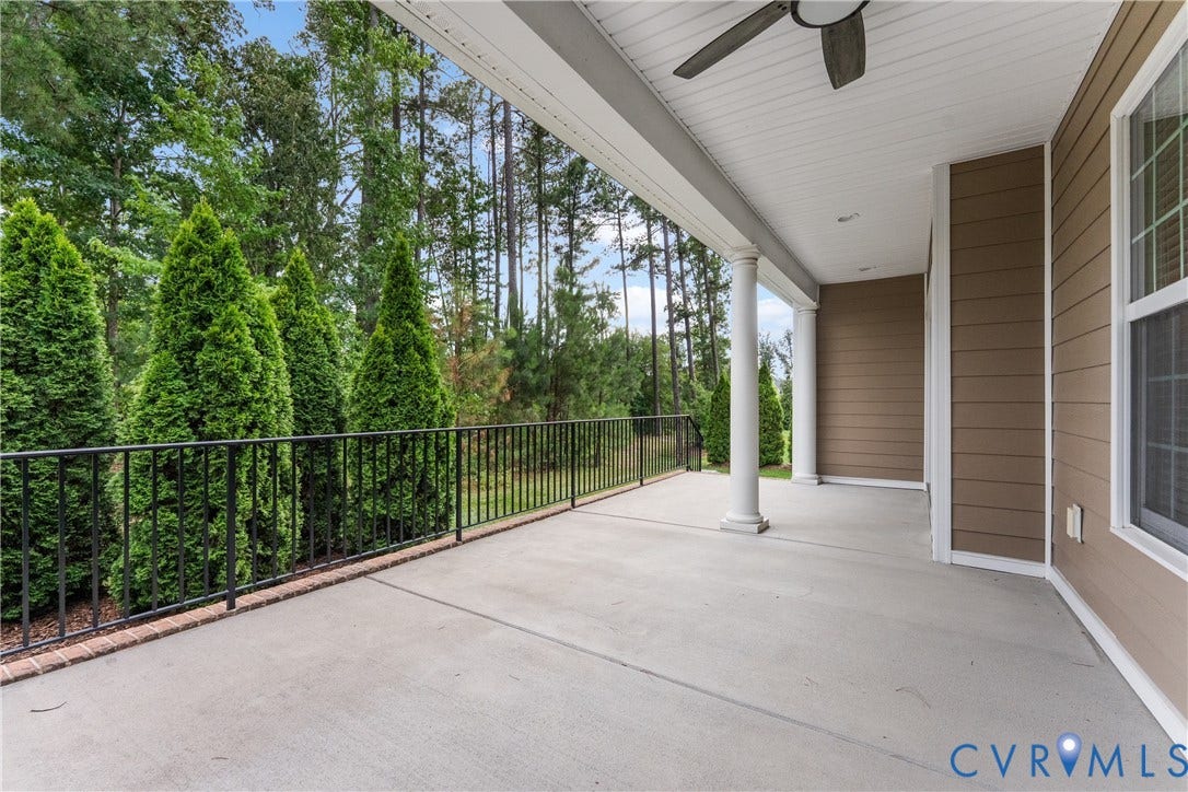 7238 Shenfield Avenue, Minutes To Short Pump, Glen Allen, VA 23059 Expansive concrete patio featuring a black metal railing, white architectural columns, a ceiling fan, and brown horizontal siding