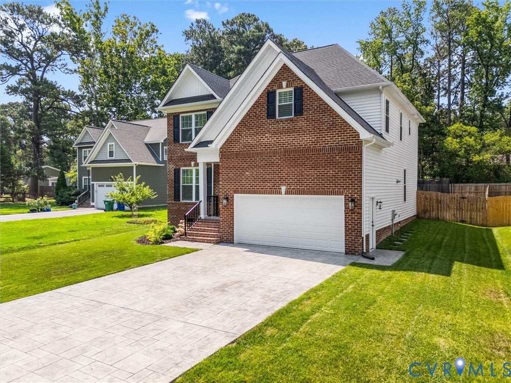 9011 Midway Road, Henrico, VA 23229 Two-story residence featuring a brick and white siding exterior, dark shingle roof, and a two-car garage