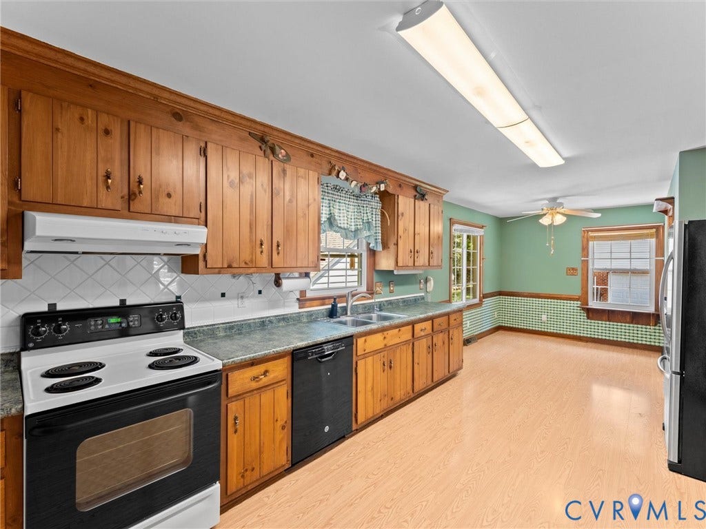 Kitchen featuring wood cabinetry, white tiled backsplash, wood-finish flooring, and a ceiling fan