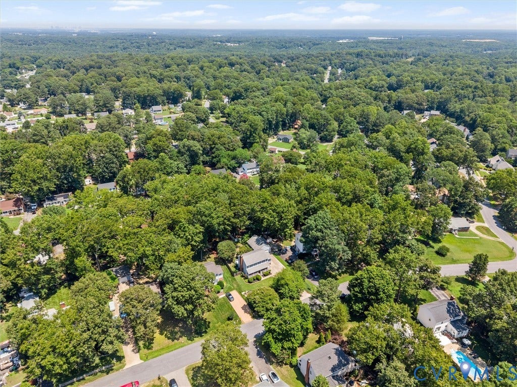 Aerial overview showcasing a residential area with extensive tree canopy and meandering roadways