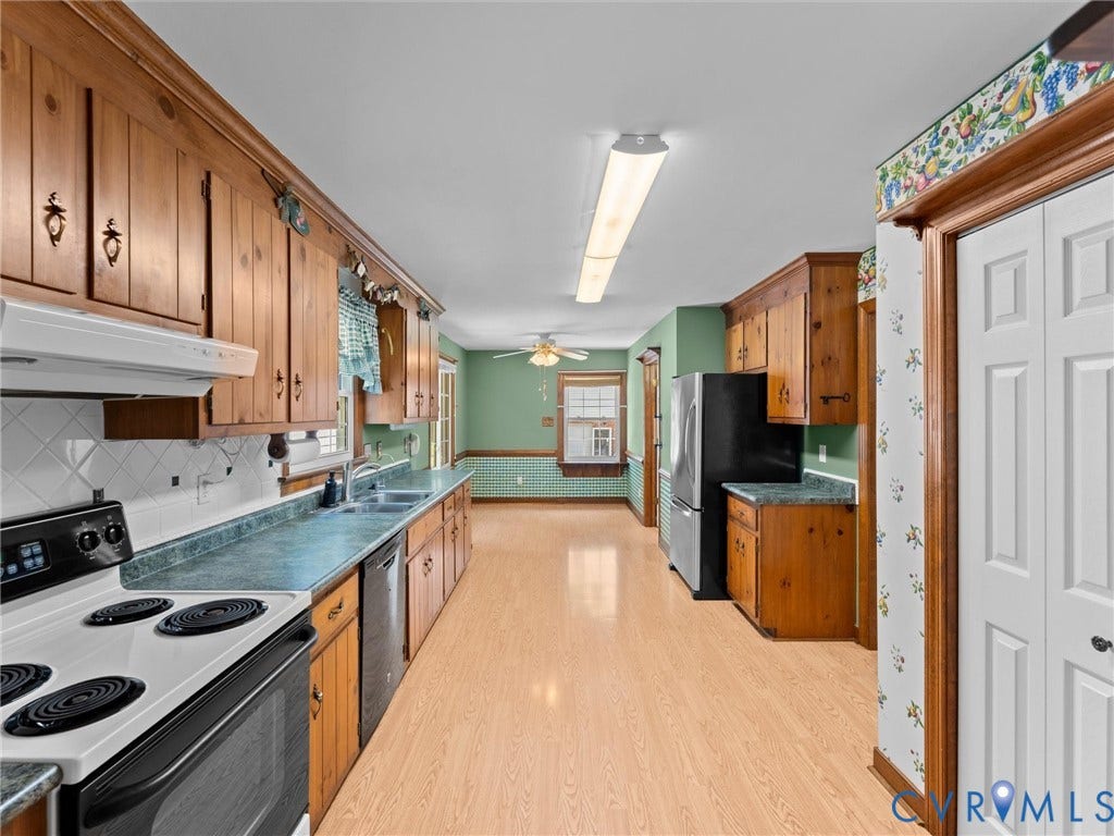 Kitchen featuring wood cabinetry, light wood-finish flooring, and a white tile backsplash
