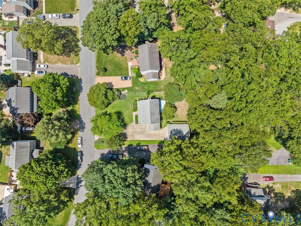 Aerial perspective showcasing residential properties with mature tree coverage