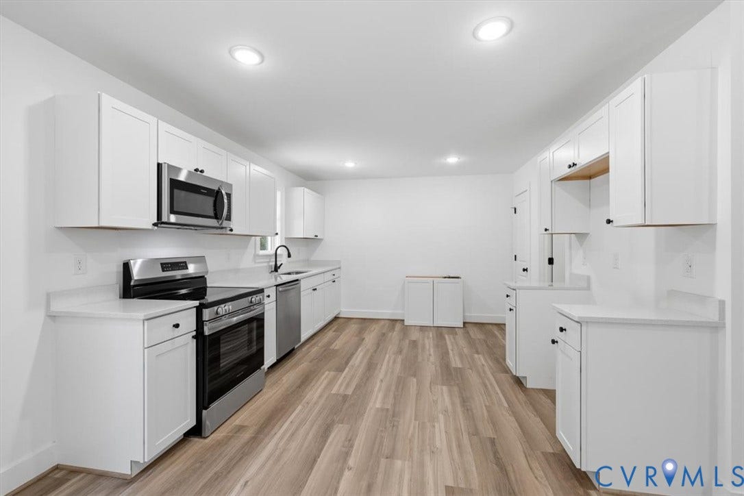 654 Frenchs Store Road, Cumberland, VA 23040 Bright kitchen featuring white shaker cabinetry, stainless steel appliances, light countertops, wood-finish flooring, and recessed lighting