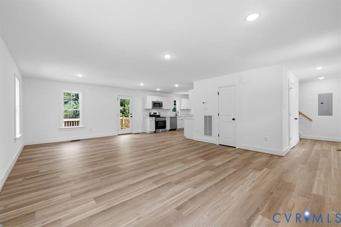 654 Frenchs Store Road, Cumberland, VA 23040 Spacious open-concept living area featuring wood-finish flooring, recessed lighting, and bright white walls