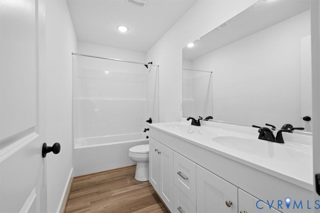 654 Frenchs Store Road, Cumberland, VA 23040 Bathroom featuring a dual sink vanity with white cabinetry and matte black hardware