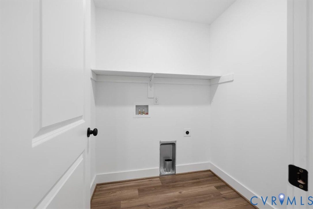 654 Frenchs Store Road, Cumberland, VA 23040 Laundry area featuring wood-finish flooring, white walls, and a built-in shelf