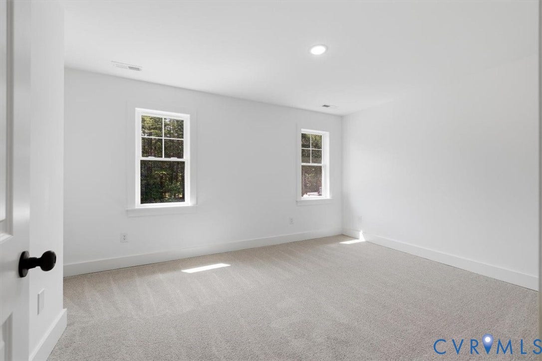 654 Frenchs Store Road, Cumberland, VA 23040 Spacious room featuring light gray carpeting, crisp white walls, two double-hung windows, recessed lighting, and white trim