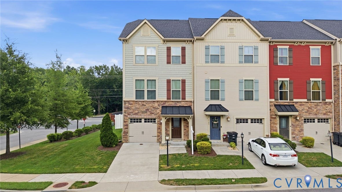 4101 New Hermitage Drive, Henrico, VA 23228 Three-story townhome featuring a stone and siding facade, individual garages, and private driveways