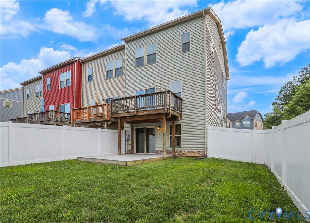 4101 New Hermitage Drive, Henrico, VA 23228 Expansive fenced backyard featuring a grassy lawn, ground-level patio, and upper-level wood deck