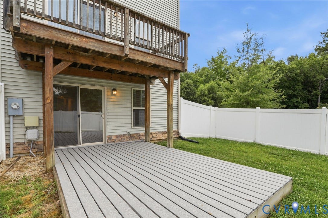 4101 New Hermitage Drive, Henrico, VA 23228 Ground-level composite decking patio under an elevated wood-finish deck with railing