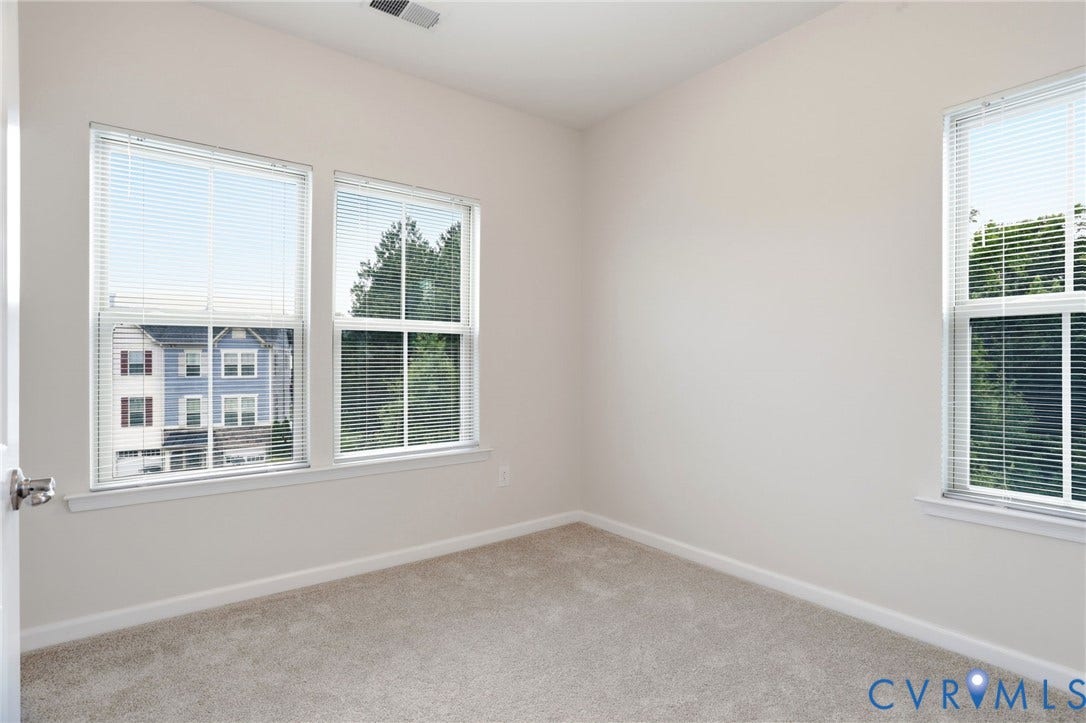 4101 New Hermitage Drive, Henrico, VA 23228 Light-filled room featuring neutral-toned carpeting and light-colored walls