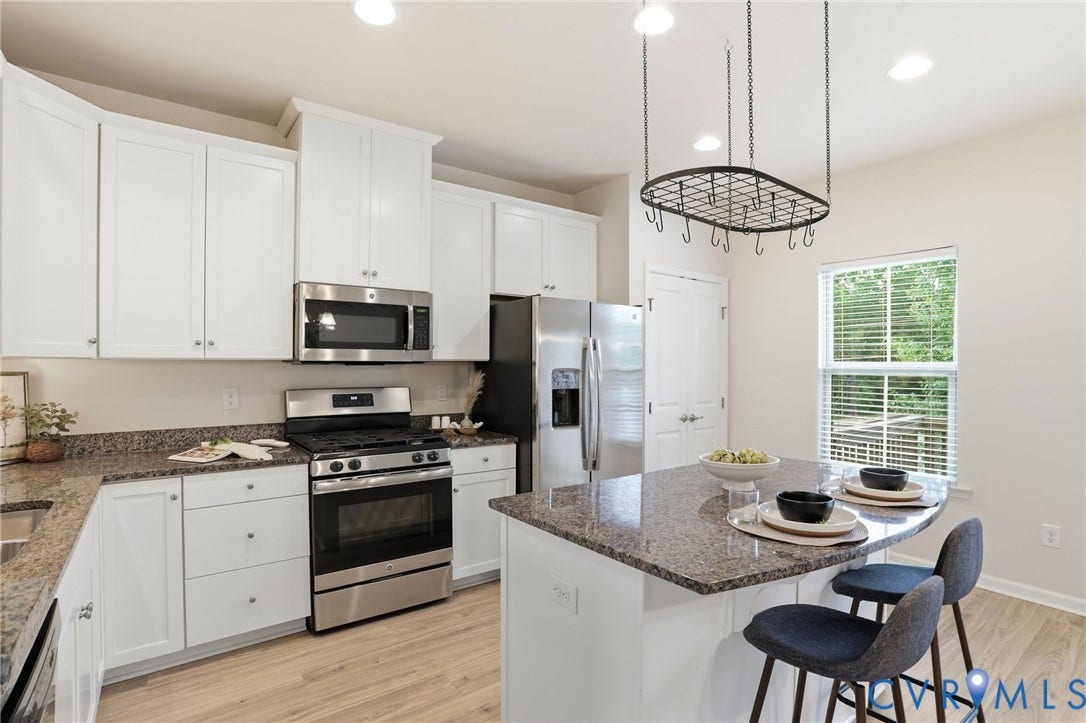 4101 New Hermitage Drive, Henrico, VA 23228 Modern kitchen featuring white cabinetry, stainless steel appliances, granite countertops, and wood-finish flooring