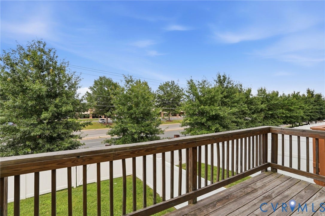 4101 New Hermitage Drive, Henrico, VA 23228 Outdoor wooden deck featuring a slatted railing and a green lawn below, bordered by a white privacy fence