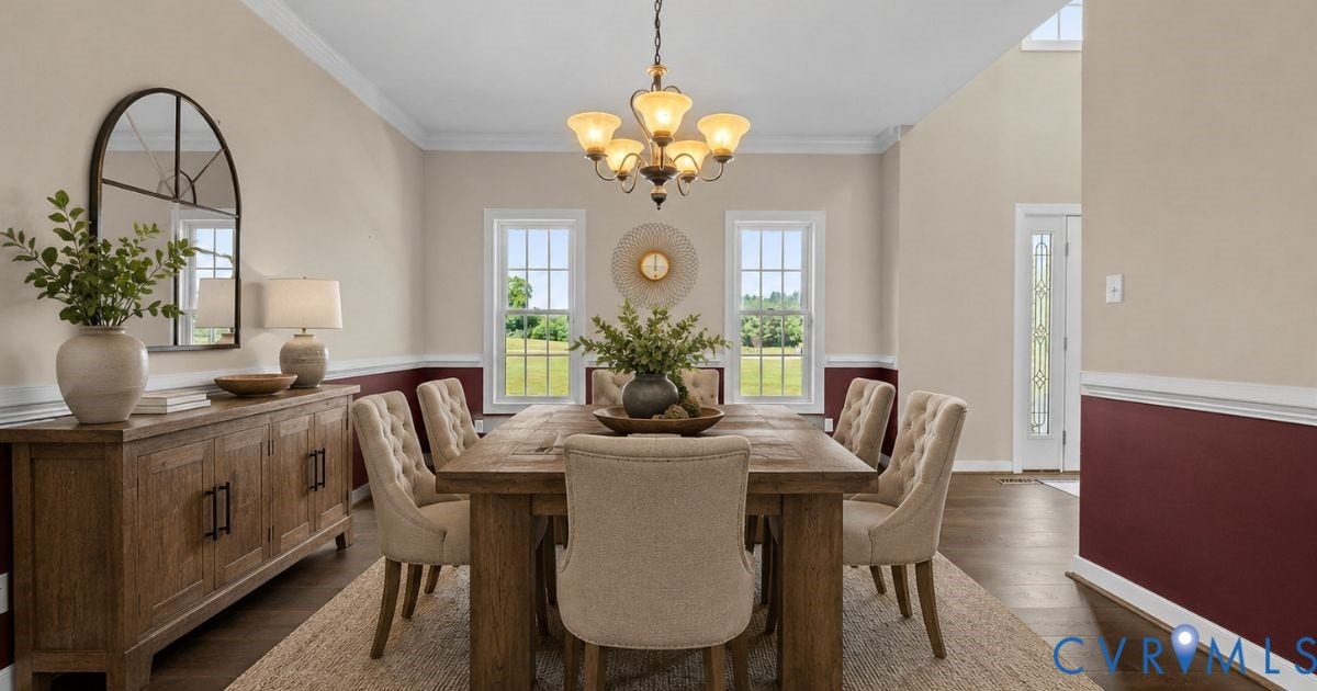 Elegant dining room showcasing hardwood flooring, a wooden dining table with upholstered chairs, and a wood-finish sideboard with cabinet storage
