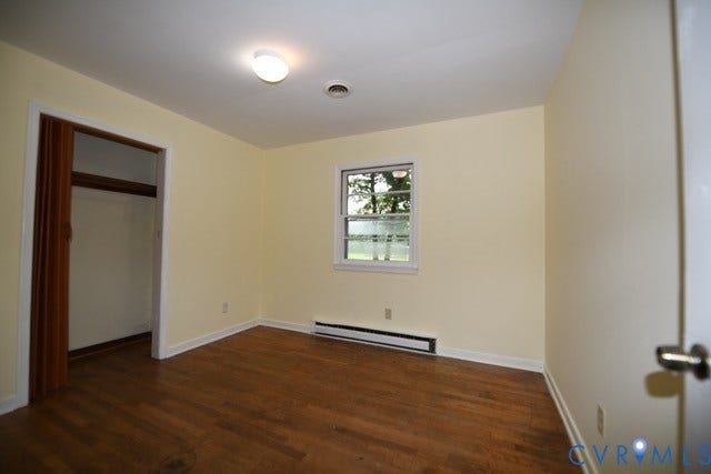 12720 Bailey Bridge Road, Bailey Bridge, Midlothian, VA 23112 Room featuring wood-finish flooring, a single window, and a built-in closet with bifold doors