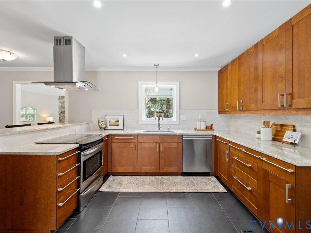 9630 Goneway Drive, Henrico, VA 23238 Induction cooking pairs with generous counter space and a sleek statement vent hood.