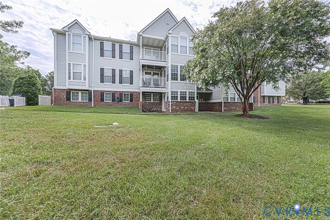 Back of Condo with lots of green space