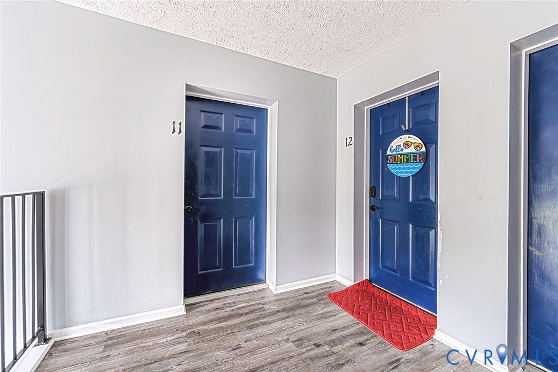 Entry corridor featuring wood-finish flooring and light gray walls