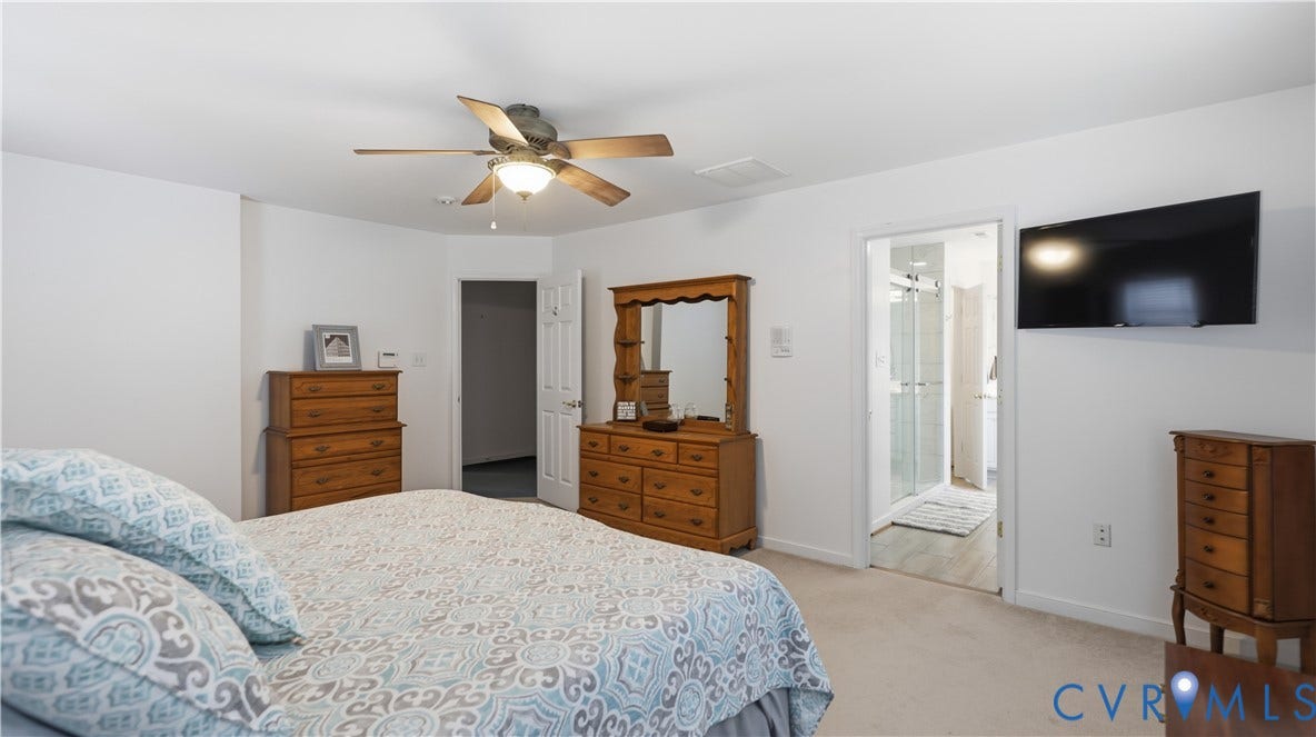1836 Rocky Ford Road, Powhatan, VA 23139 Spacious bedroom with neutral-toned carpeting and white walls