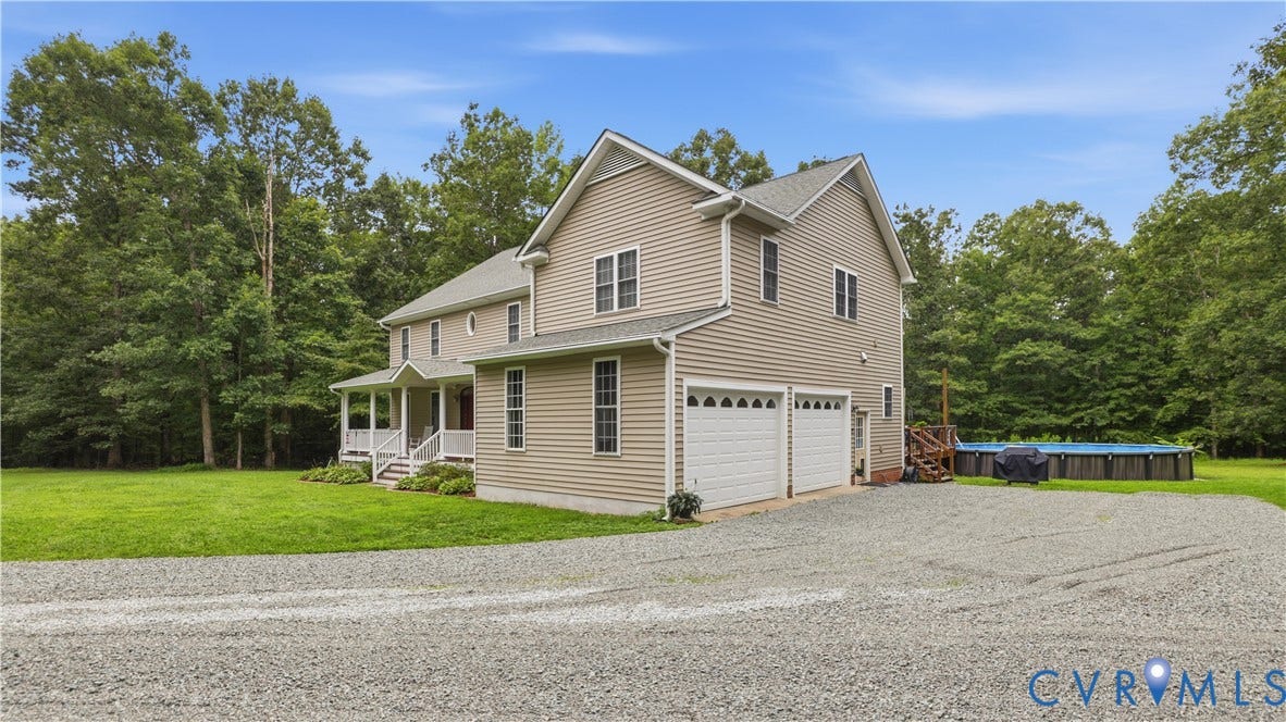 1836 Rocky Ford Road, Powhatan, VA 23139 Three-story residence featuring light-toned siding and a prominent two-car garage