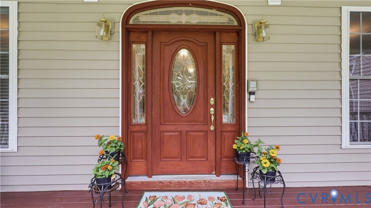 1836 Rocky Ford Road, Powhatan, VA 23139 Stained wood entry door with oval leaded glass, flanked by two sidelights and an arched transom featuring decorative glass
