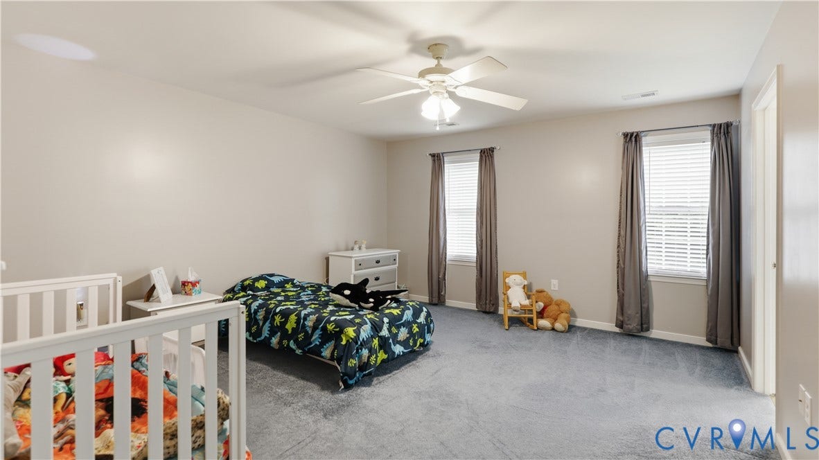 1836 Rocky Ford Road, Powhatan, VA 23139 Spacious room featuring neutral painted walls, light gray carpet, and two windows with blinds and drapes