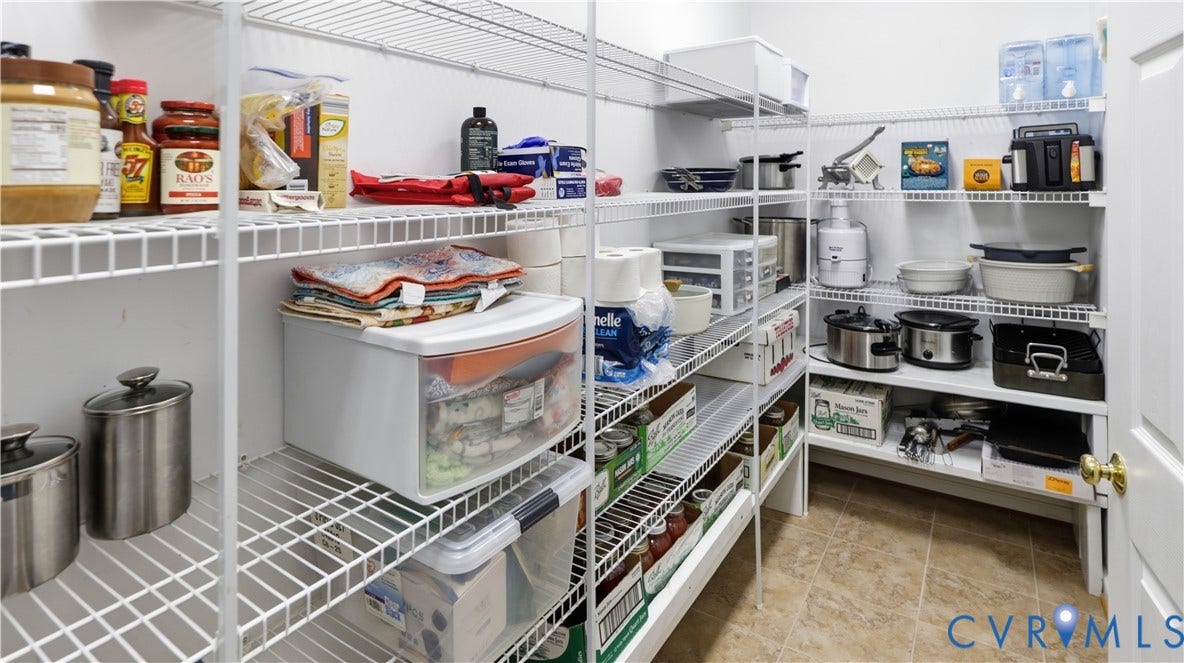 1836 Rocky Ford Road, Powhatan, VA 23139 Walk-in pantry featuring wire shelving, multiple storage levels, neutral-toned flooring, and a white interior door