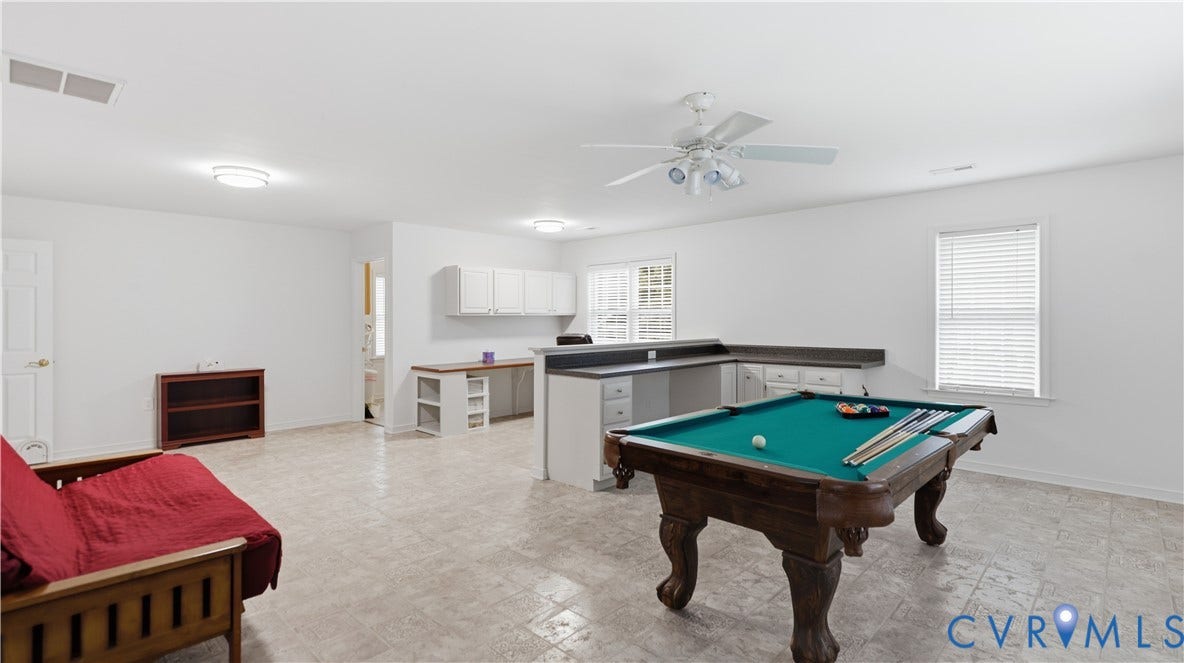 1836 Rocky Ford Road, Powhatan, VA 23139 Spacious room featuring light-toned tile flooring, white walls, and a built-in L-shaped counter with lower cabinets