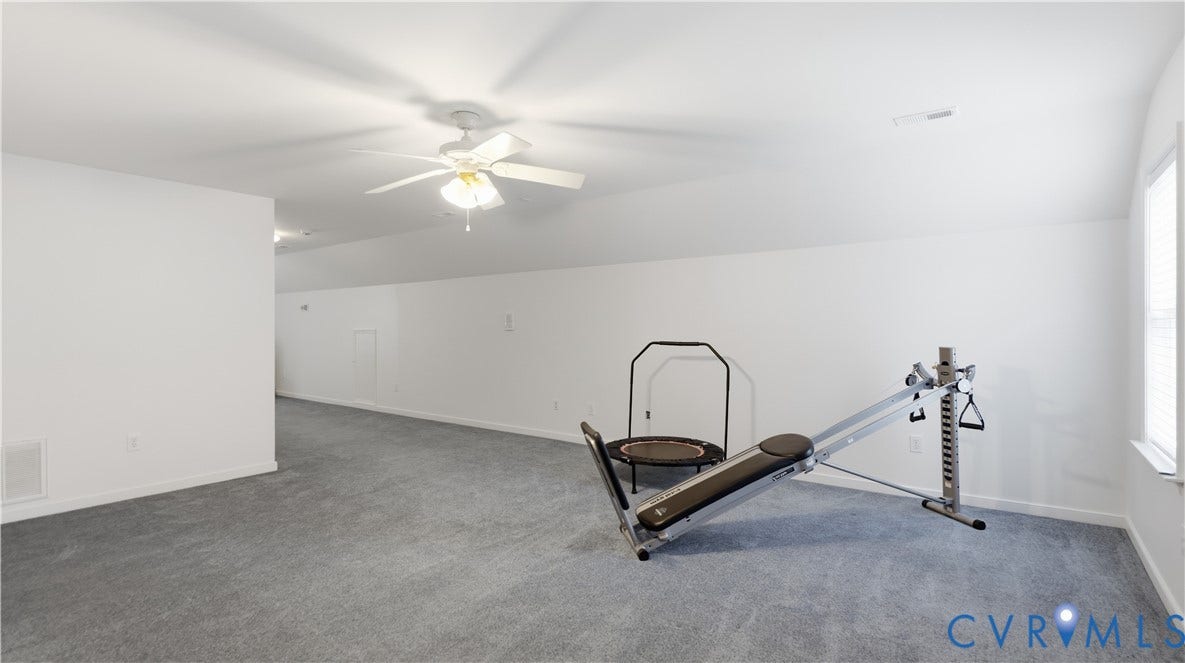 1836 Rocky Ford Road, Powhatan, VA 23139 Spacious room featuring light gray carpeting, crisp white walls, a ceiling fan with integrated lighting, and a single window offering natural light