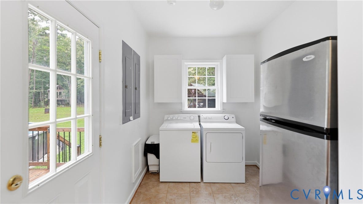 1836 Rocky Ford Road, Powhatan, VA 23139 Utility area featuring a paneled exterior door with glass inserts, transom window, recessed laundry appliances, overhead cabinetry, and tile flooring